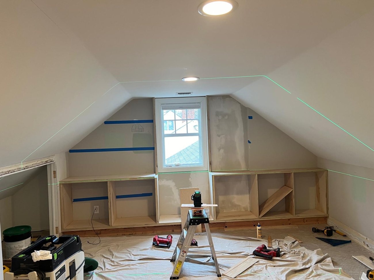 Attic before: bare boxes and laser level lines