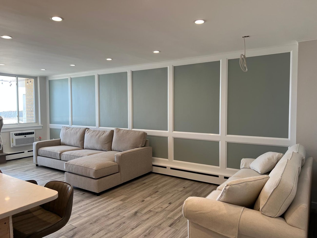 Custom wall panel molding in a renovated living room