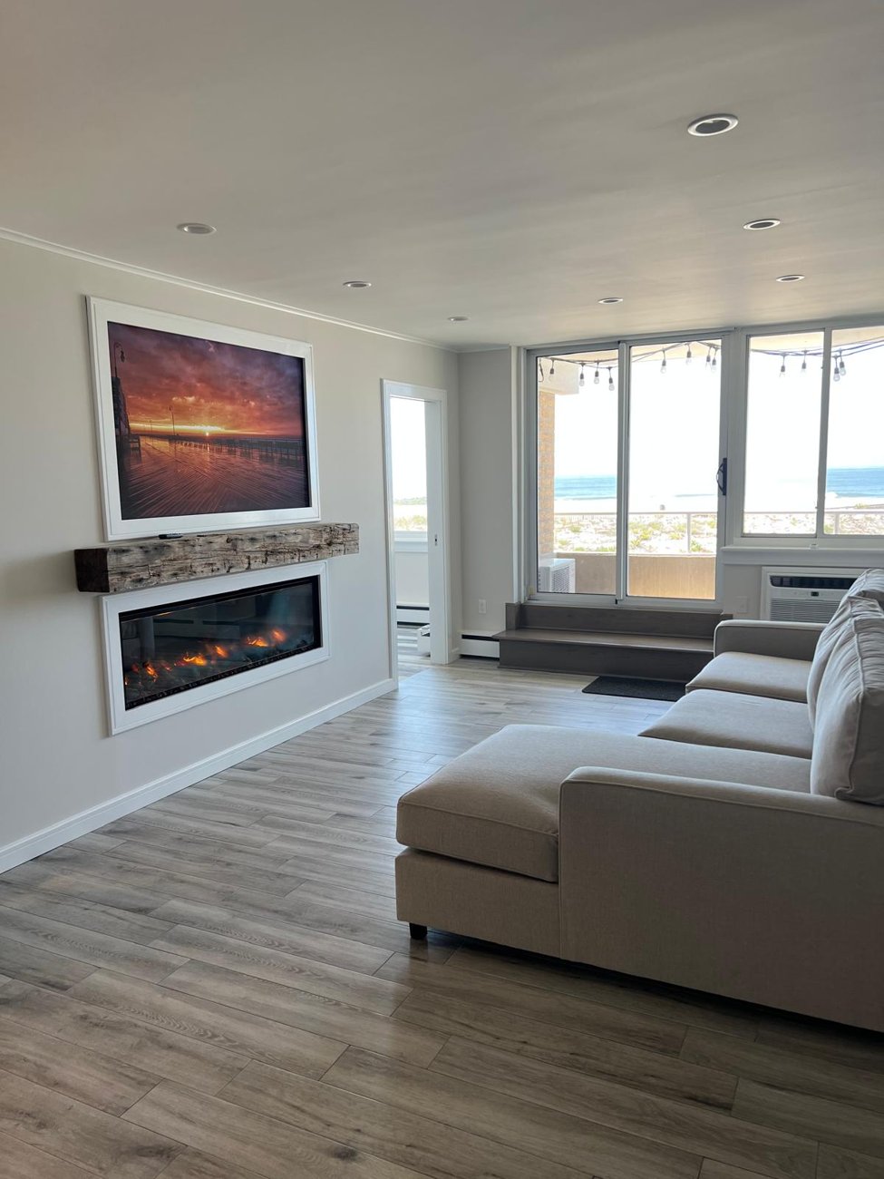 New wood-look flooring through a renovated living room