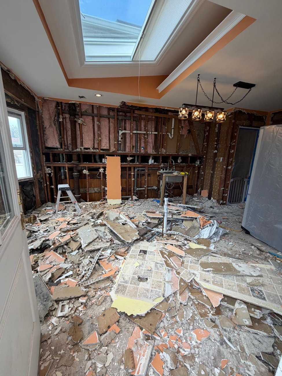 Old walls out, skylight staying, everything else new
