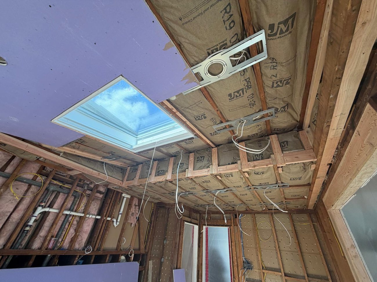 New insulation and lighting laid out around the skylight