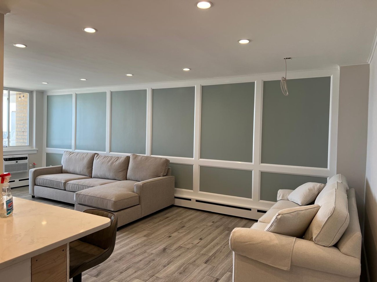 Living room with painted panel walls, clean lines between colors