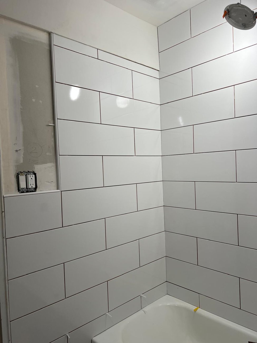 White subway tile shower walls, clean straight lines